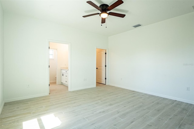 unfurnished bedroom featuring connected bathroom, ceiling fan, and light wood-type flooring