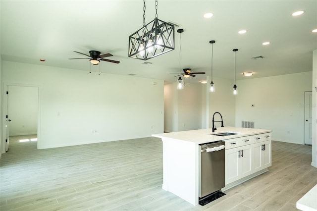 kitchen featuring sink, light hardwood / wood-style flooring, stainless steel dishwasher, an island with sink, and white cabinetry