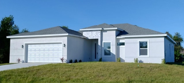 view of front facade with a garage and a front lawn