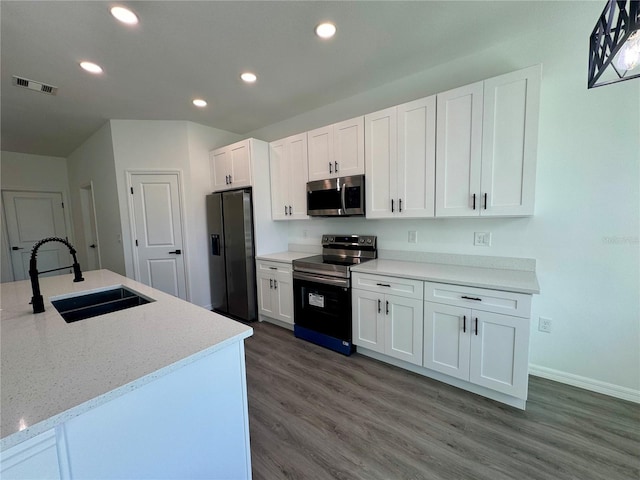 kitchen with white cabinets, stainless steel appliances, dark wood-type flooring, and sink