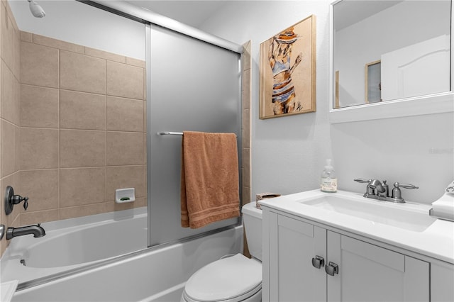 full bathroom featuring vanity with extensive cabinet space, enclosed tub / shower combo, and toilet