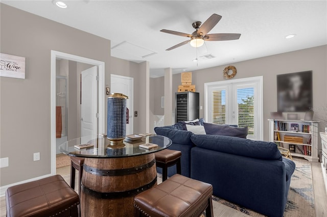 living room featuring ceiling fan and light wood-type flooring