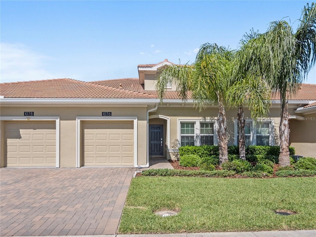 view of front of home with a front yard and a garage