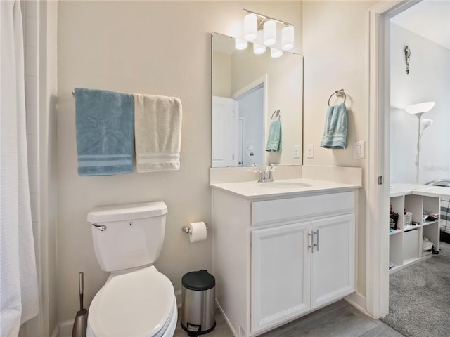 bathroom with vanity, toilet, and walk in shower