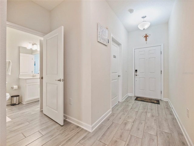 foyer with sink and light wood-type flooring