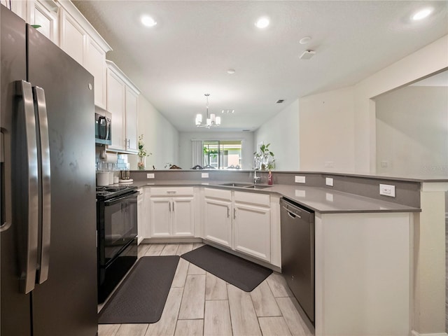 kitchen with stainless steel appliances, light wood-type flooring, kitchen peninsula, and white cabinets