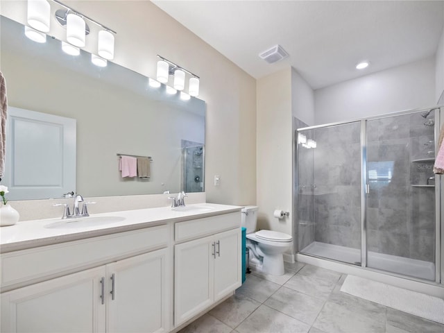 bathroom with vanity, toilet, an enclosed shower, and tile patterned floors