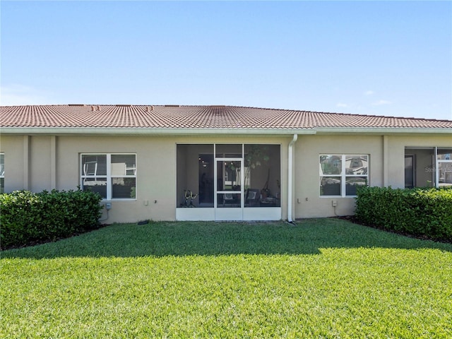 rear view of property with a yard