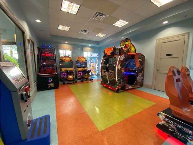 playroom with tile patterned floors and a drop ceiling