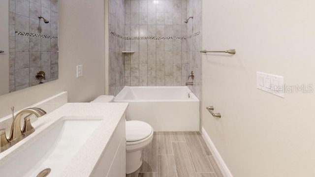 full bathroom featuring vanity, toilet, and tiled shower / bath combo