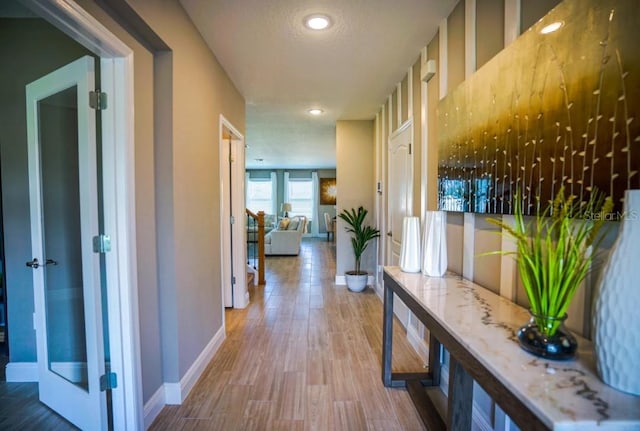 hall featuring hardwood / wood-style flooring and a textured ceiling