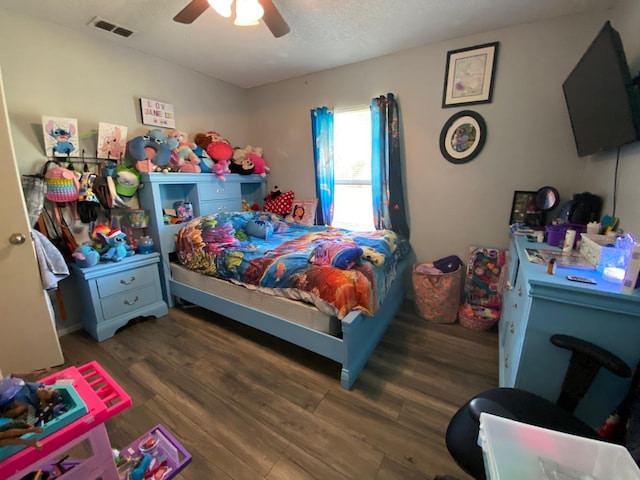 bedroom with ceiling fan and dark wood-type flooring