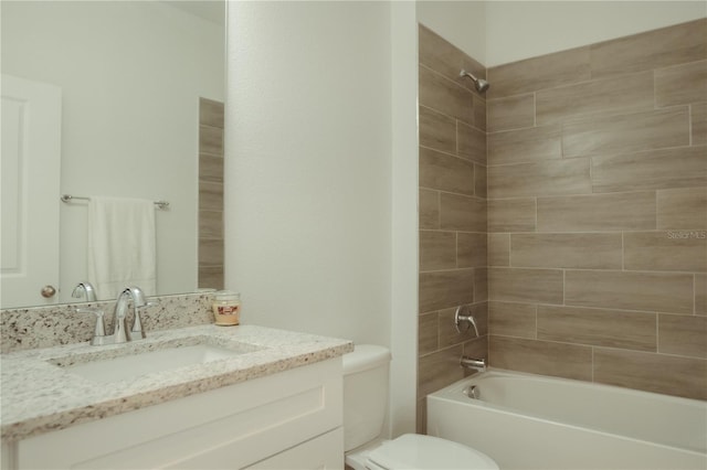 full bathroom featuring vanity, tiled shower / bath combo, and toilet