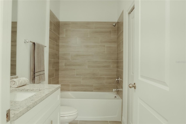 full bathroom with tiled shower / bath combo, vanity, tile floors, and toilet