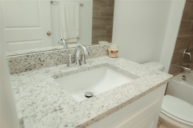 full bathroom with toilet, oversized vanity, and tiled shower / bath combo