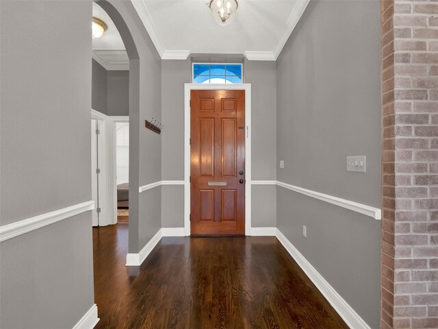 entryway featuring crown molding and dark hardwood / wood-style flooring