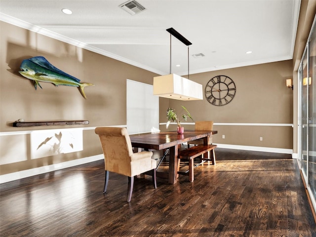 dining room with crown molding and dark hardwood / wood-style floors