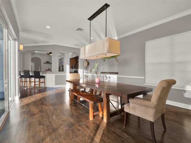 dining area featuring dark hardwood / wood-style floors, ceiling fan, and crown molding