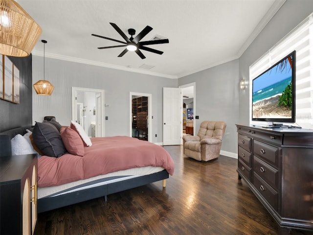 bedroom with ceiling fan, a spacious closet, ensuite bathroom, and ornamental molding