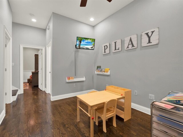 rec room with ceiling fan and dark wood-type flooring