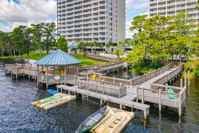 view of dock with a gazebo and a water view