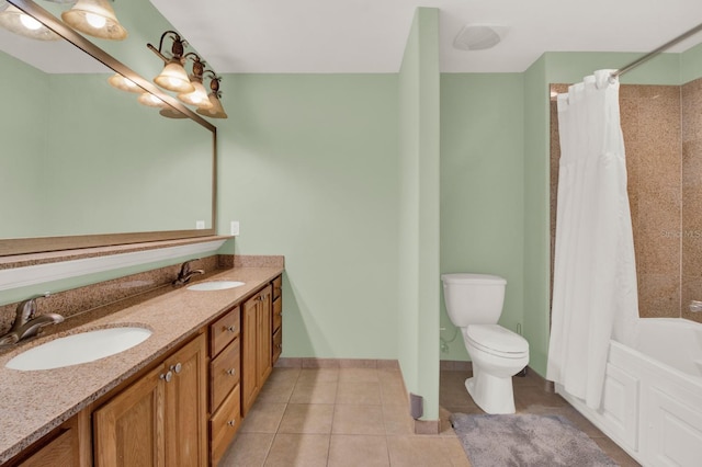 bathroom with tile patterned flooring, vanity, and toilet