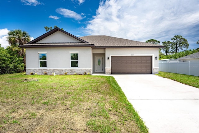 view of front of house featuring a garage and a front lawn