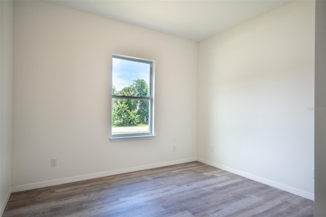 unfurnished room with hardwood / wood-style flooring