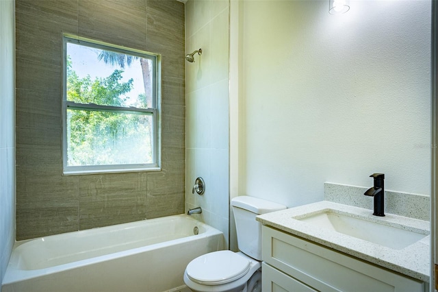 full bathroom featuring tiled shower / bath combo, vanity, and toilet