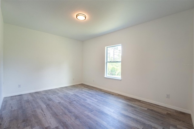 empty room featuring dark wood-type flooring