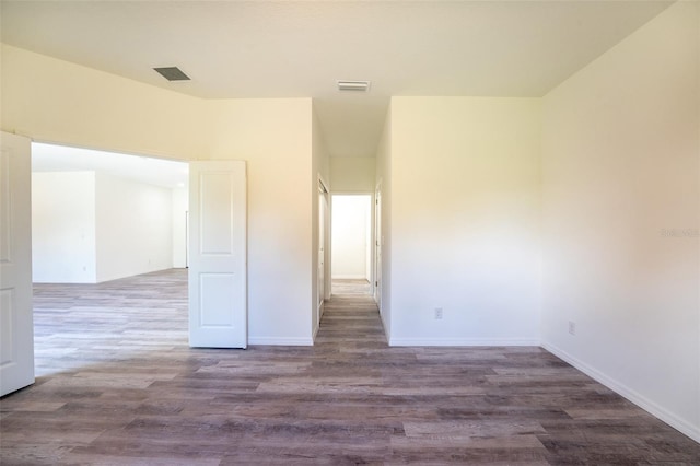 empty room with dark hardwood / wood-style flooring