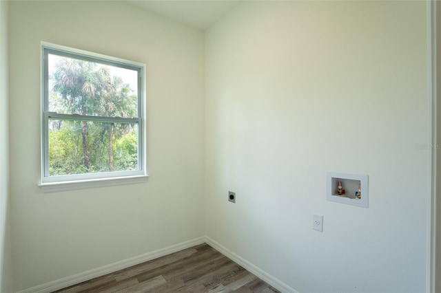 laundry room with electric dryer hookup, hookup for a washing machine, a wealth of natural light, and wood-type flooring