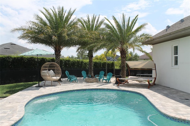 view of swimming pool with a patio area and an outdoor fire pit