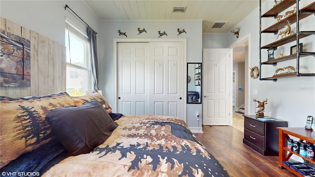 bedroom with a closet and dark hardwood / wood-style flooring