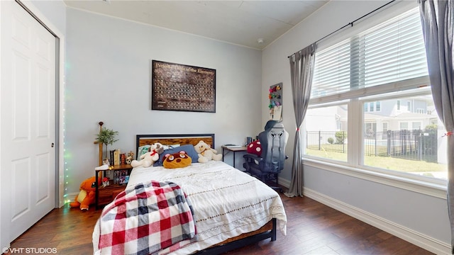 bedroom with a closet and dark hardwood / wood-style floors