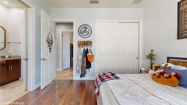 bedroom featuring wood-type flooring and a closet