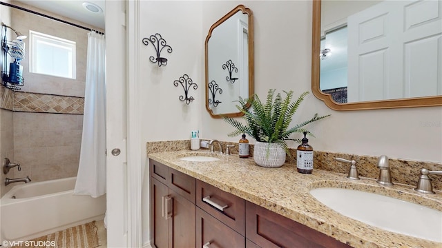 bathroom with shower / bath combo and dual vanity