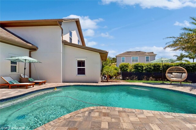 view of swimming pool with a patio area