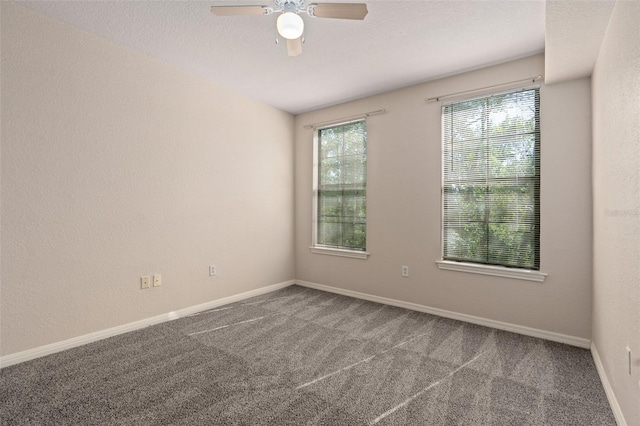 carpeted empty room with ceiling fan and a textured ceiling