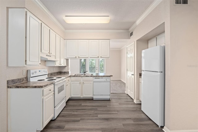 kitchen featuring white appliances, a textured ceiling, dark wood-type flooring, white cabinets, and crown molding