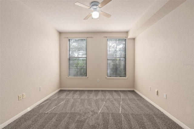 empty room featuring a textured ceiling, carpet flooring, and ceiling fan