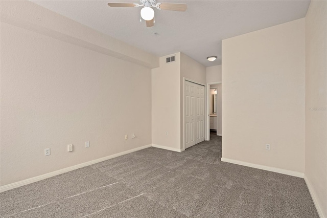 unfurnished bedroom featuring dark carpet and ceiling fan