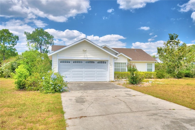 single story home featuring a garage and a front yard