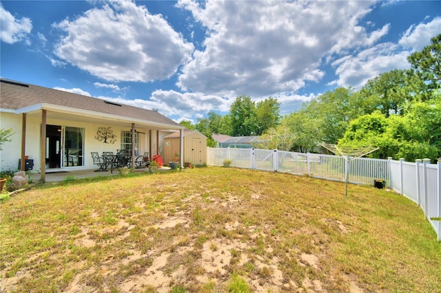 view of yard with a patio area and a storage shed