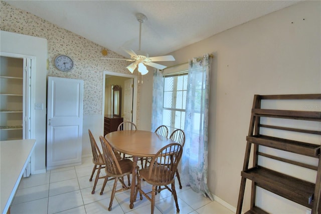 tiled dining area featuring ceiling fan and a textured ceiling