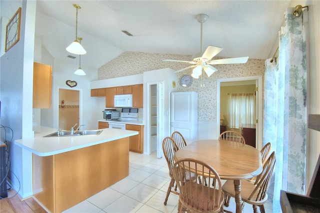 kitchen with kitchen peninsula, stove, ceiling fan, sink, and lofted ceiling