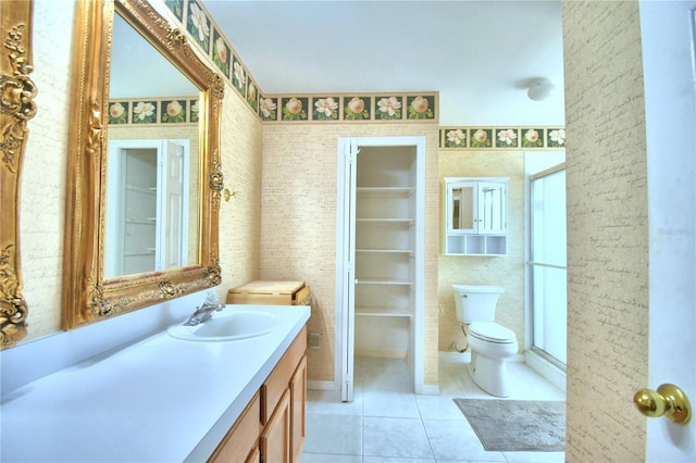 bathroom featuring tile patterned flooring, vanity, and toilet