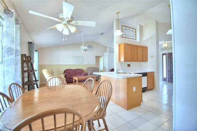 tiled dining space featuring ceiling fan, lofted ceiling, and sink