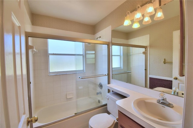 full bathroom with vanity, a healthy amount of sunlight, toilet, and enclosed tub / shower combo