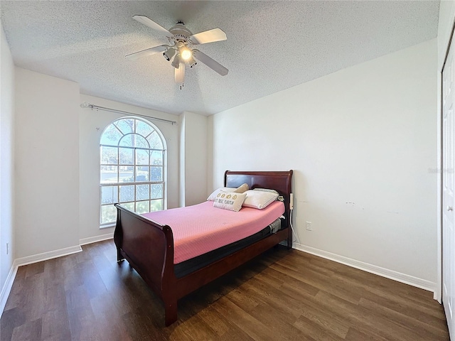 bedroom featuring a textured ceiling, dark hardwood / wood-style floors, and ceiling fan